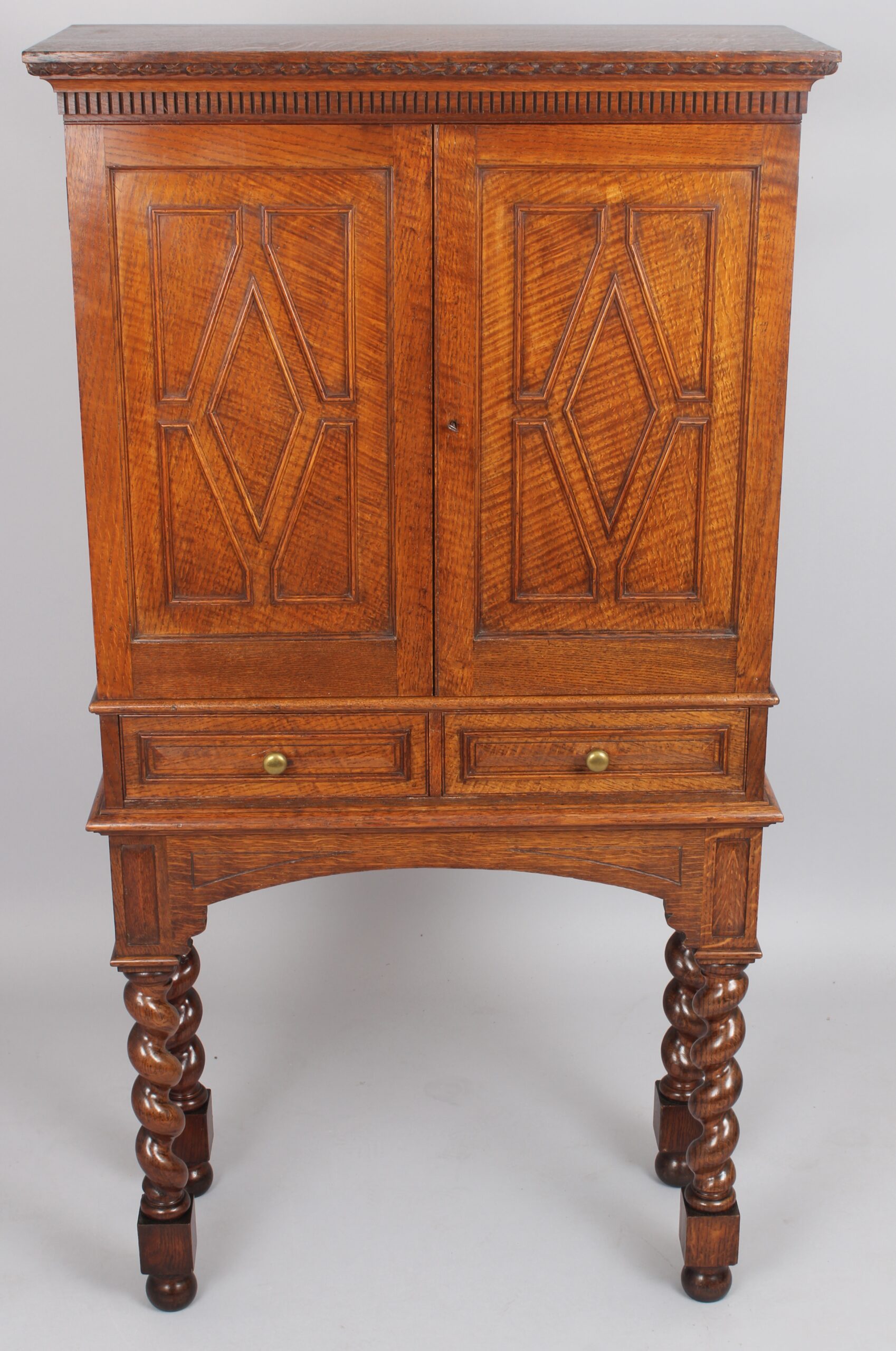 An Edwardian oak stationery cabinet