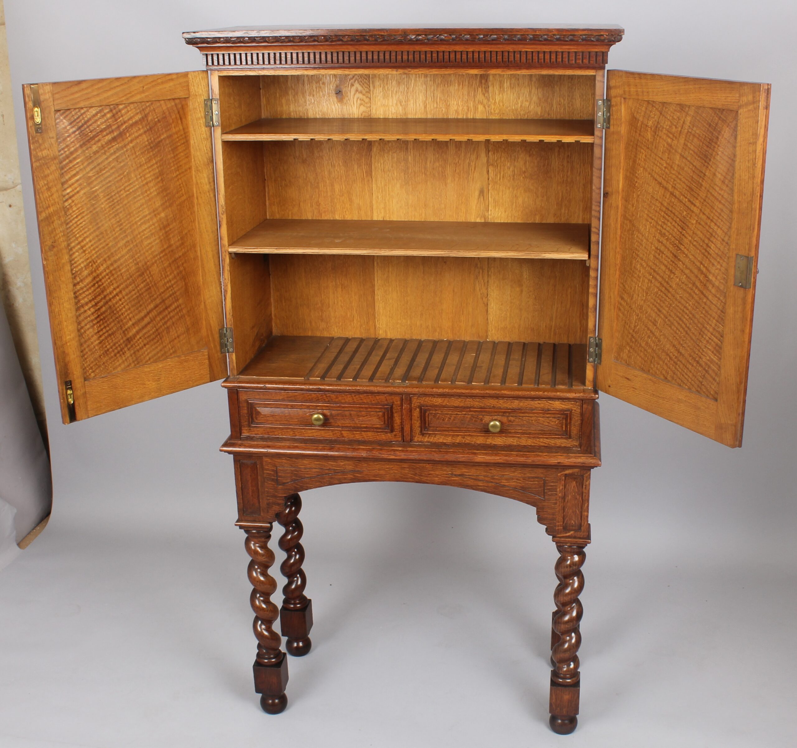 An Edwardian oak stationery cabinet