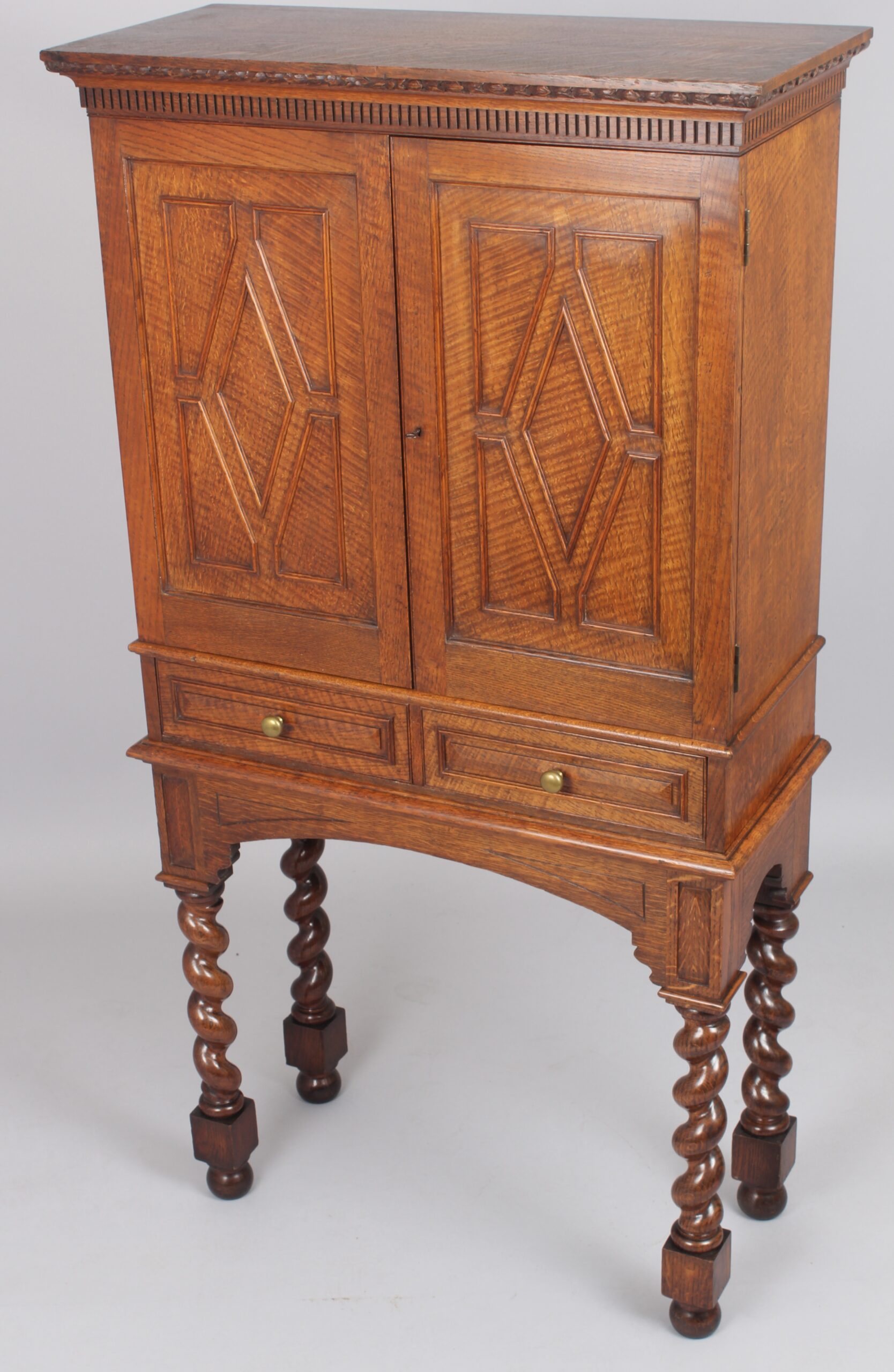An Edwardian oak stationery cabinet