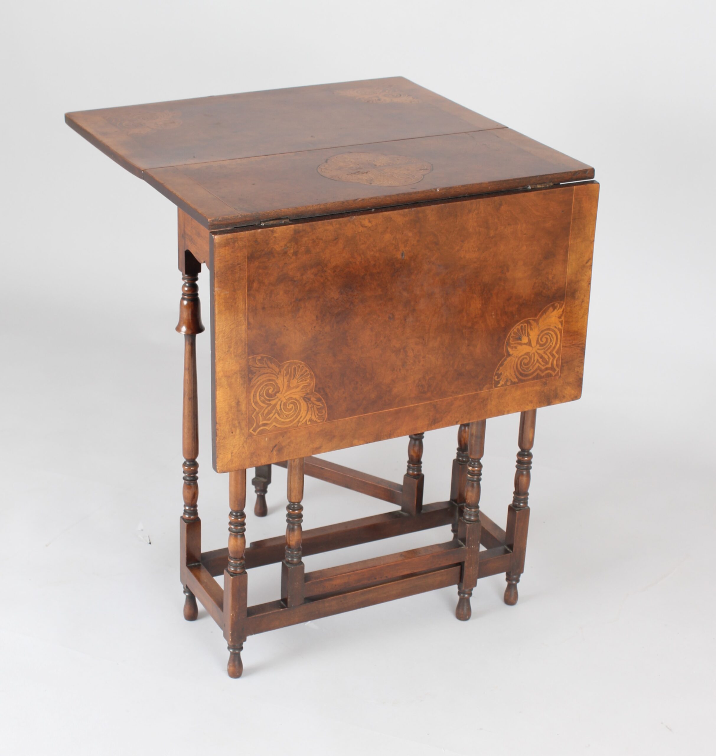 Edwardian burr walnut and parquetry Sutherland table of rare form