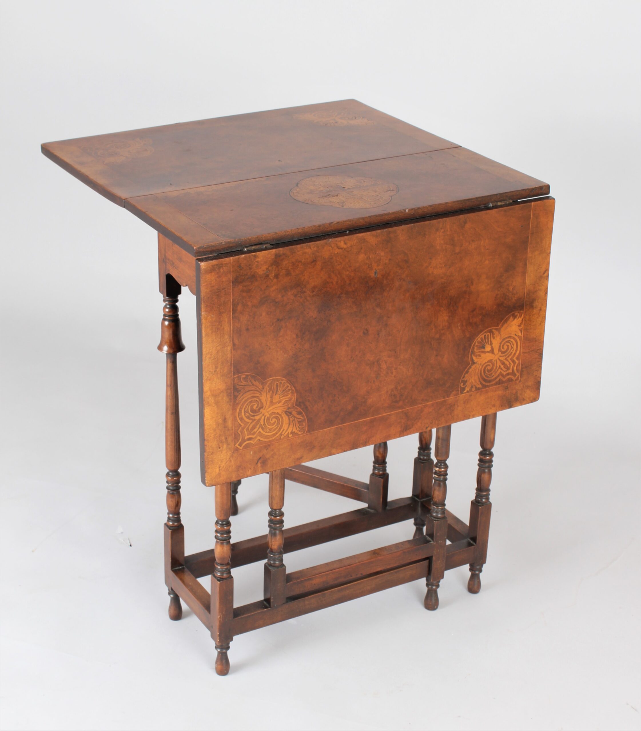 Edwardian burr walnut and parquetry Sutherland table of rare form