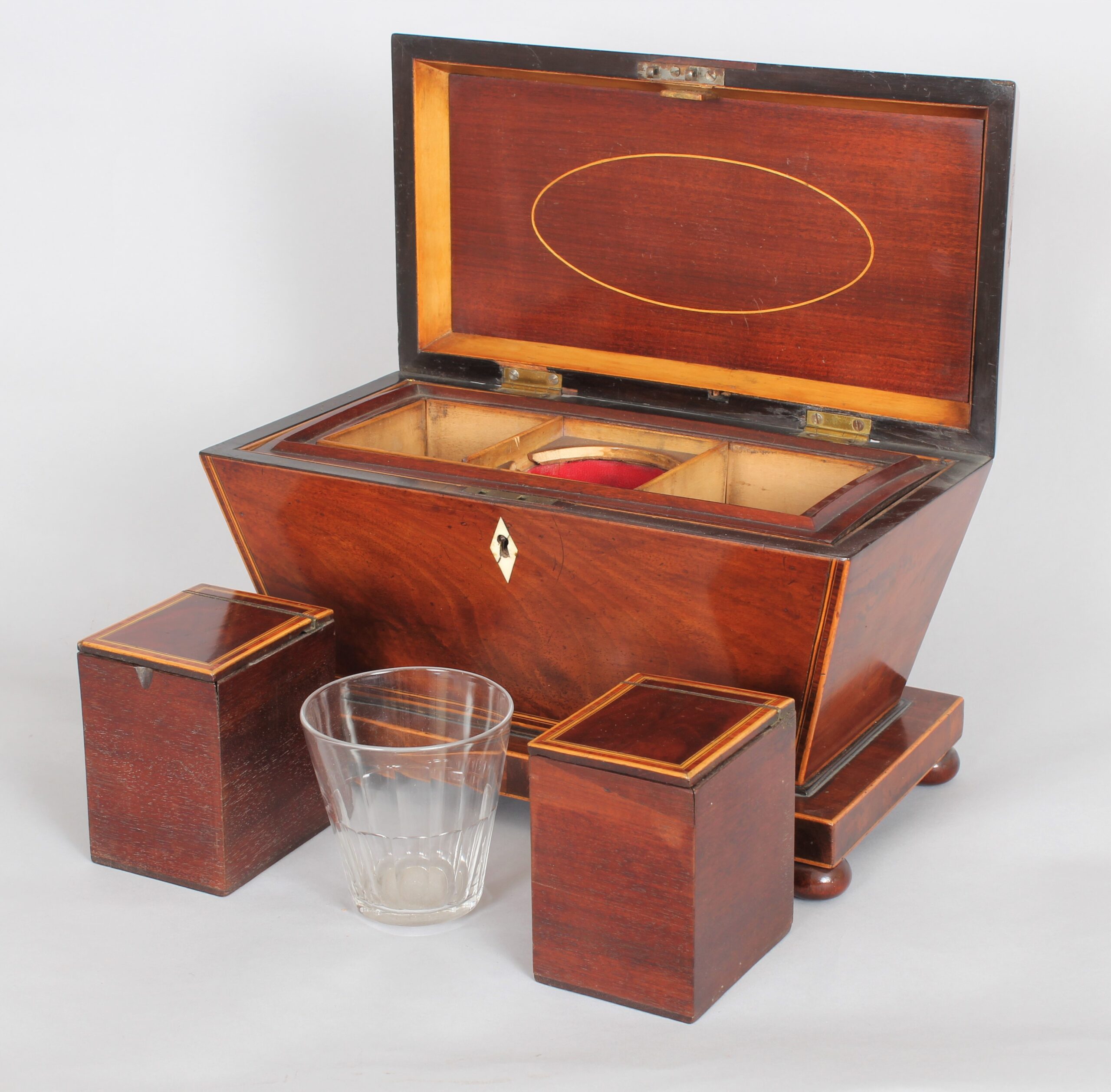 A bold mahogany sarcophagus shaped tea caddy