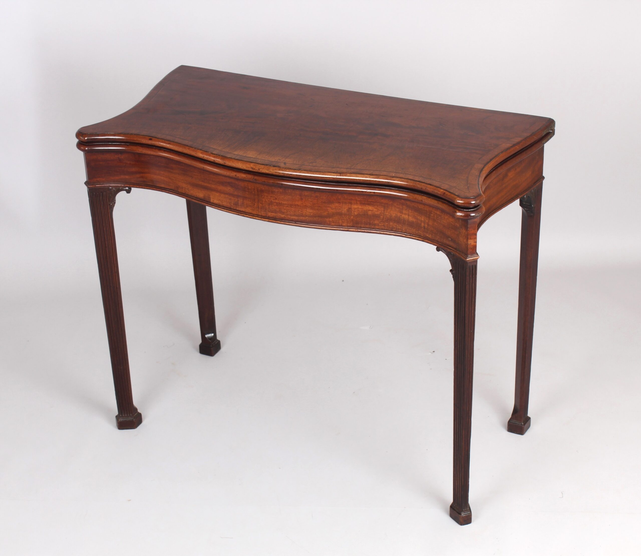 Mahogany serpentine card table