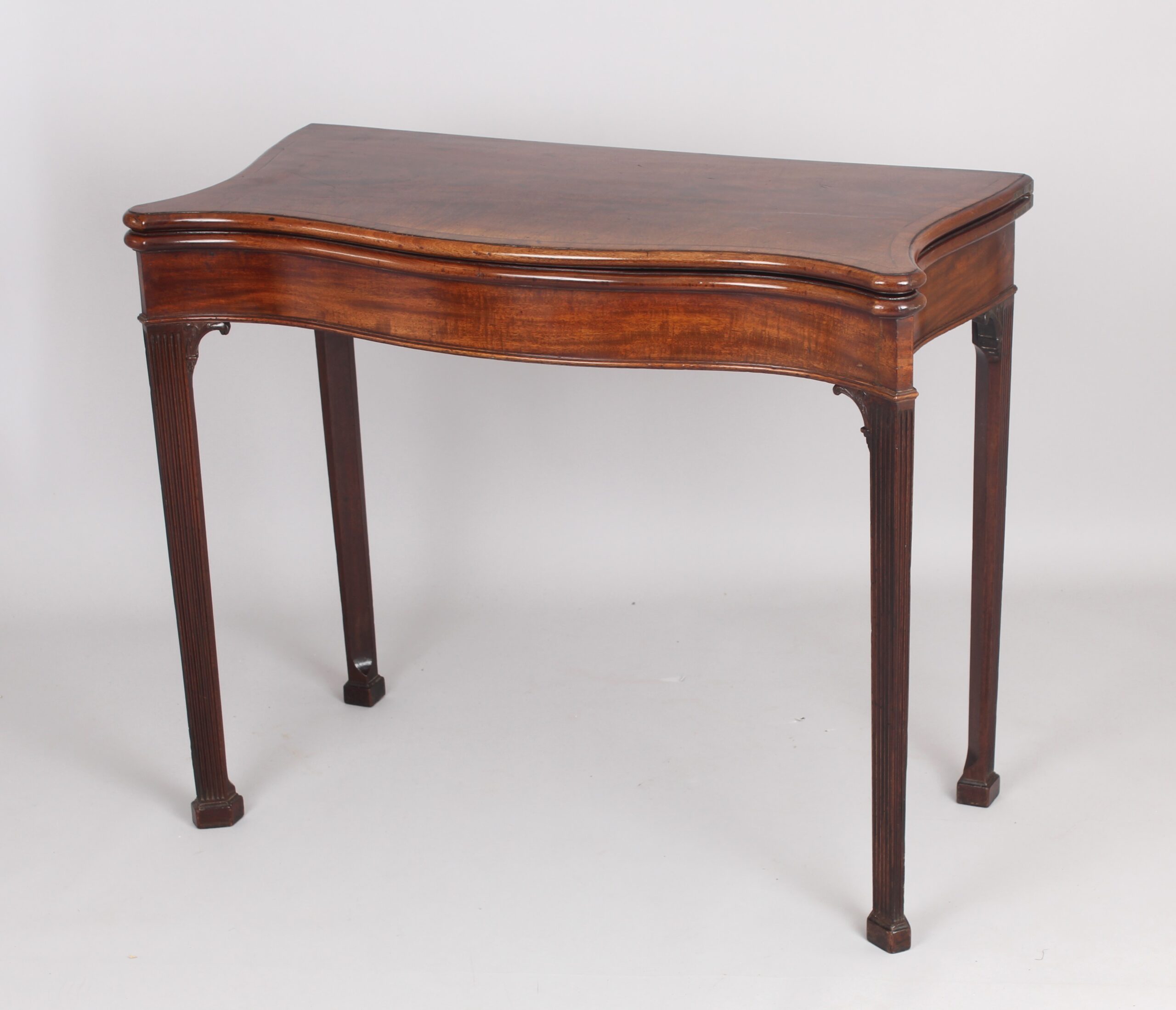 Mahogany serpentine card table