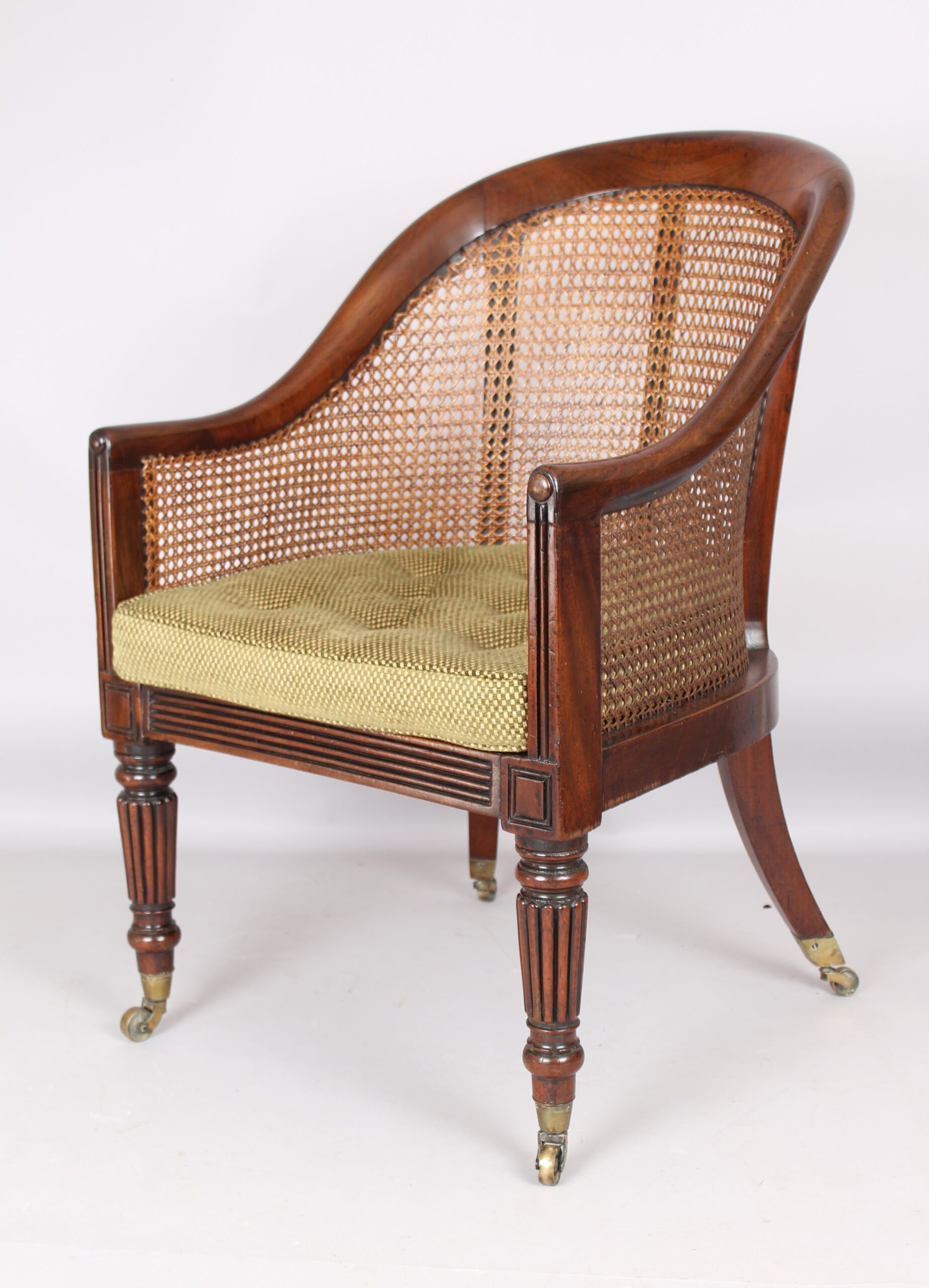 An early 19th century mahogany bergere chair