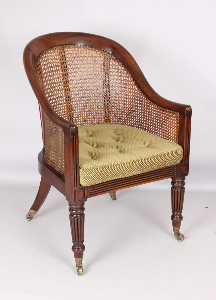An early 19th century mahogany bergere chair