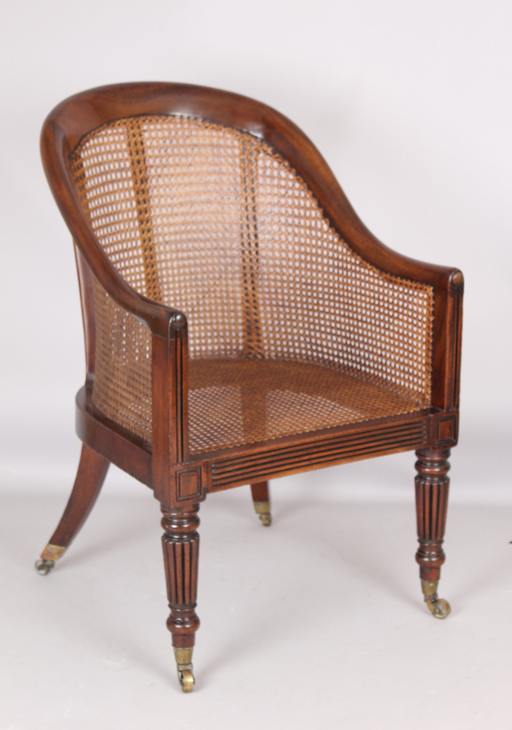 An early 19th century mahogany bergere chair