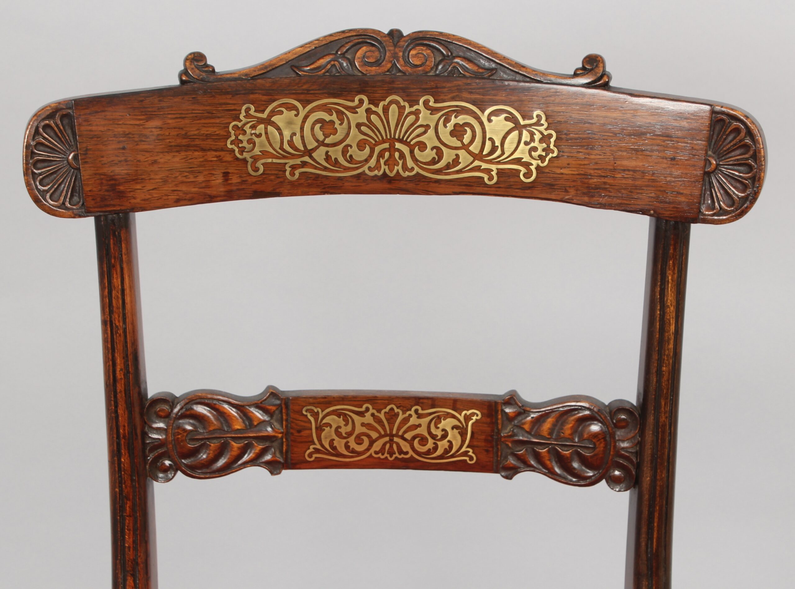 Set of eight Regency period simulated rosewood and brass inlaid chairs