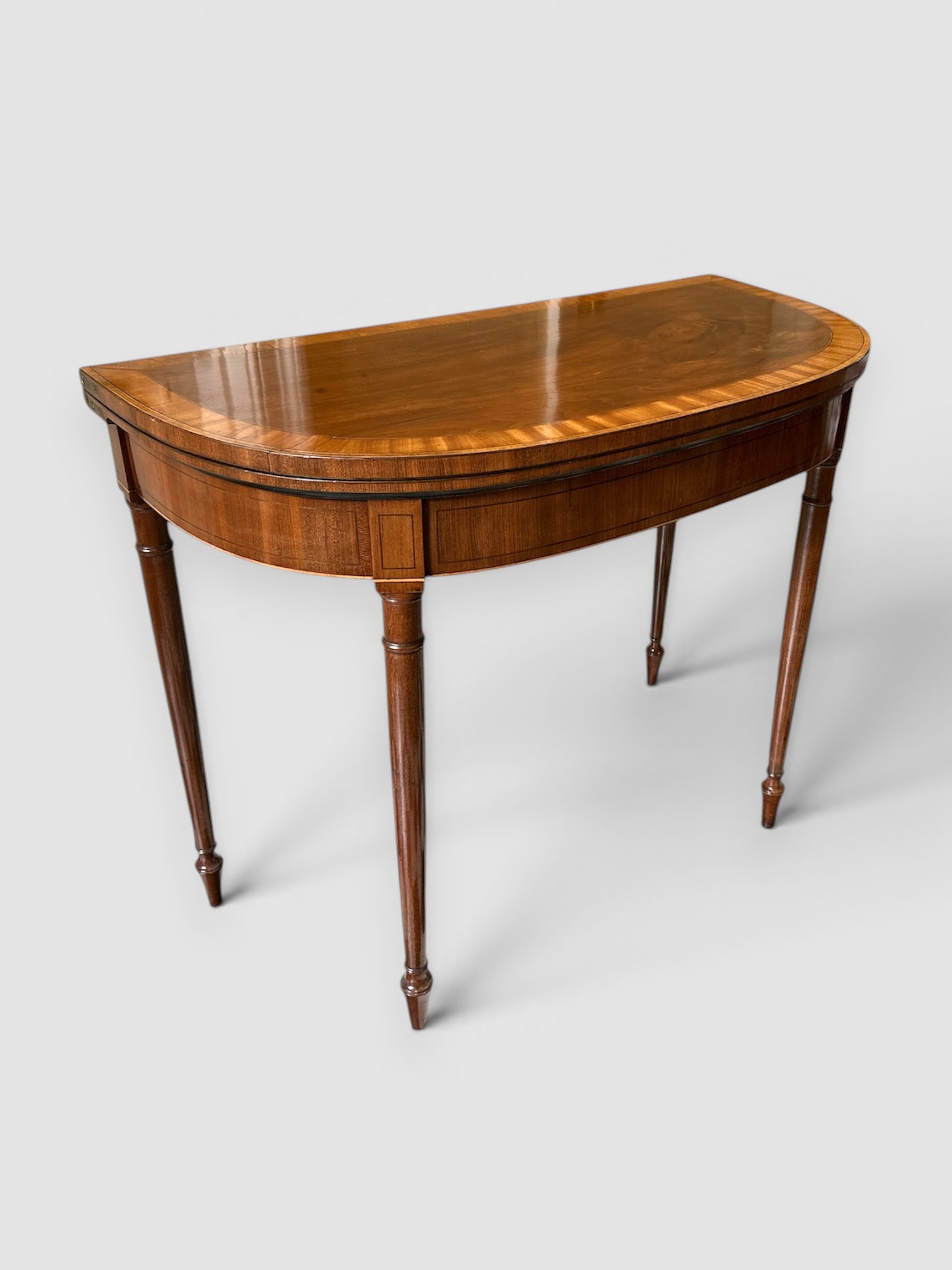 Early 19th century mahogany card table on turned tapering legs
